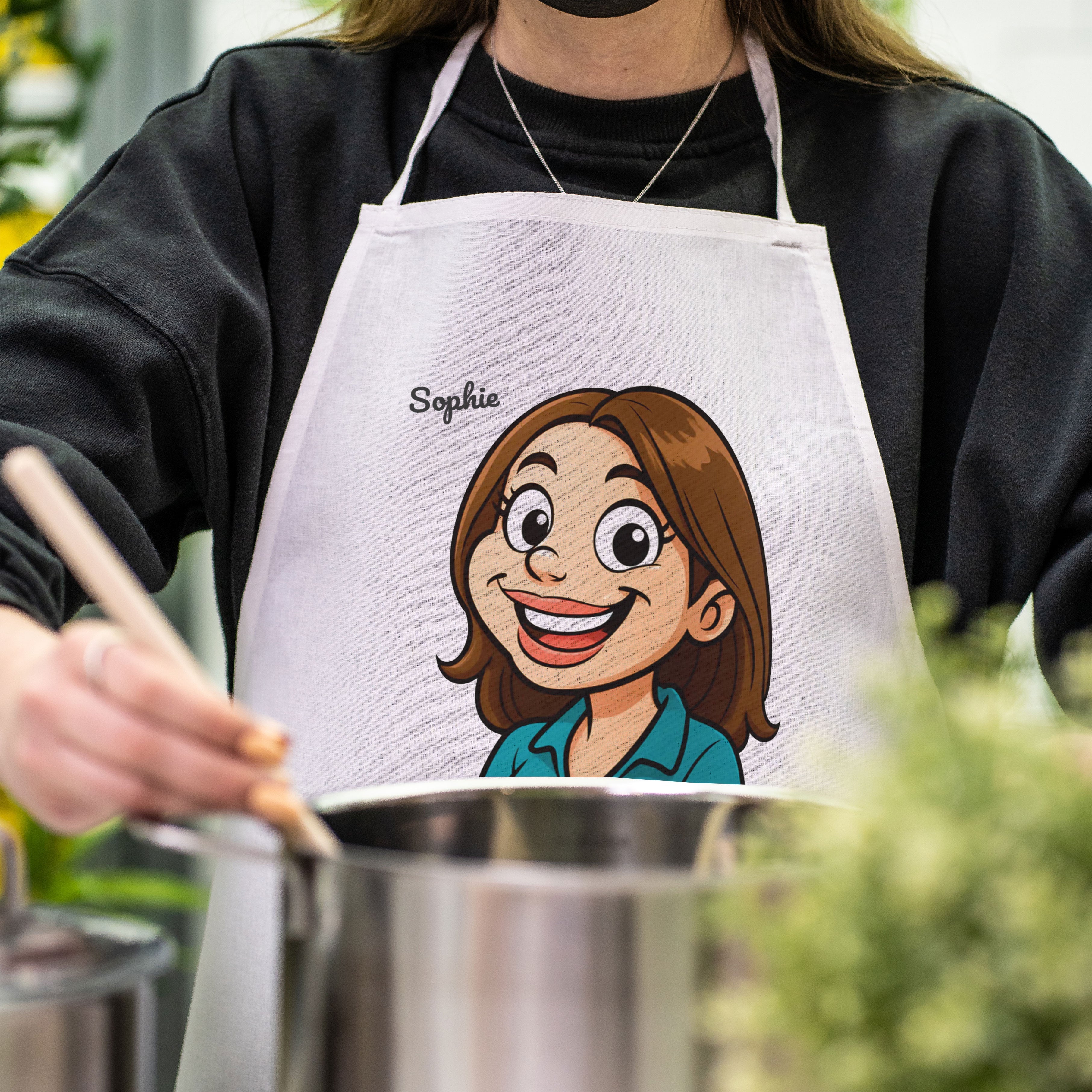 Bunte Kinder-Schürze mit lustiger Karikatur und Text, ideal für kreative Koch- und Backaktionen.